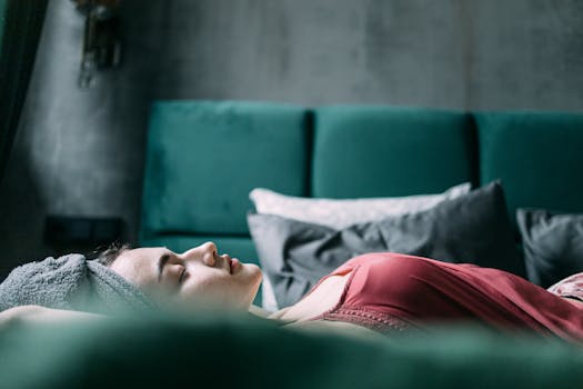 A young woman resting peacefully in a stylish and cozy bedroom setting.